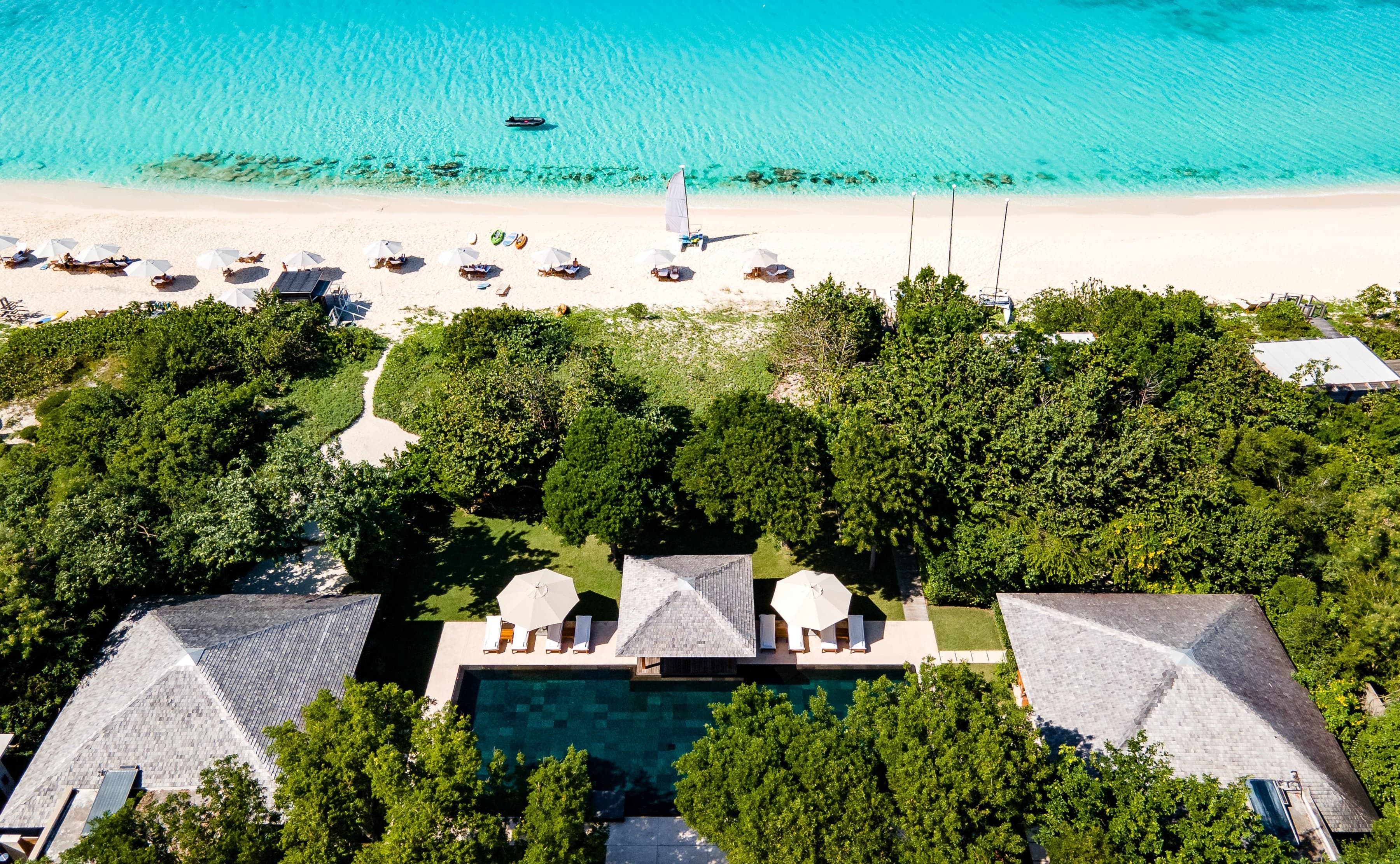 Aerial view of a villa, pool and beach