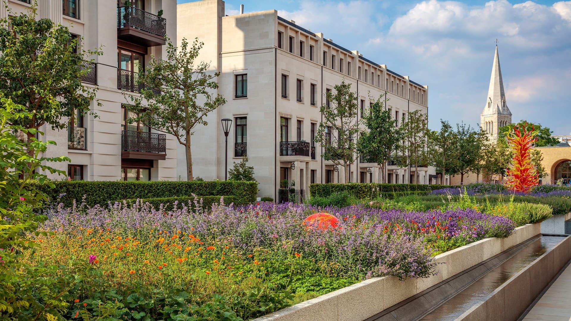 Garden square planting beside stone residences