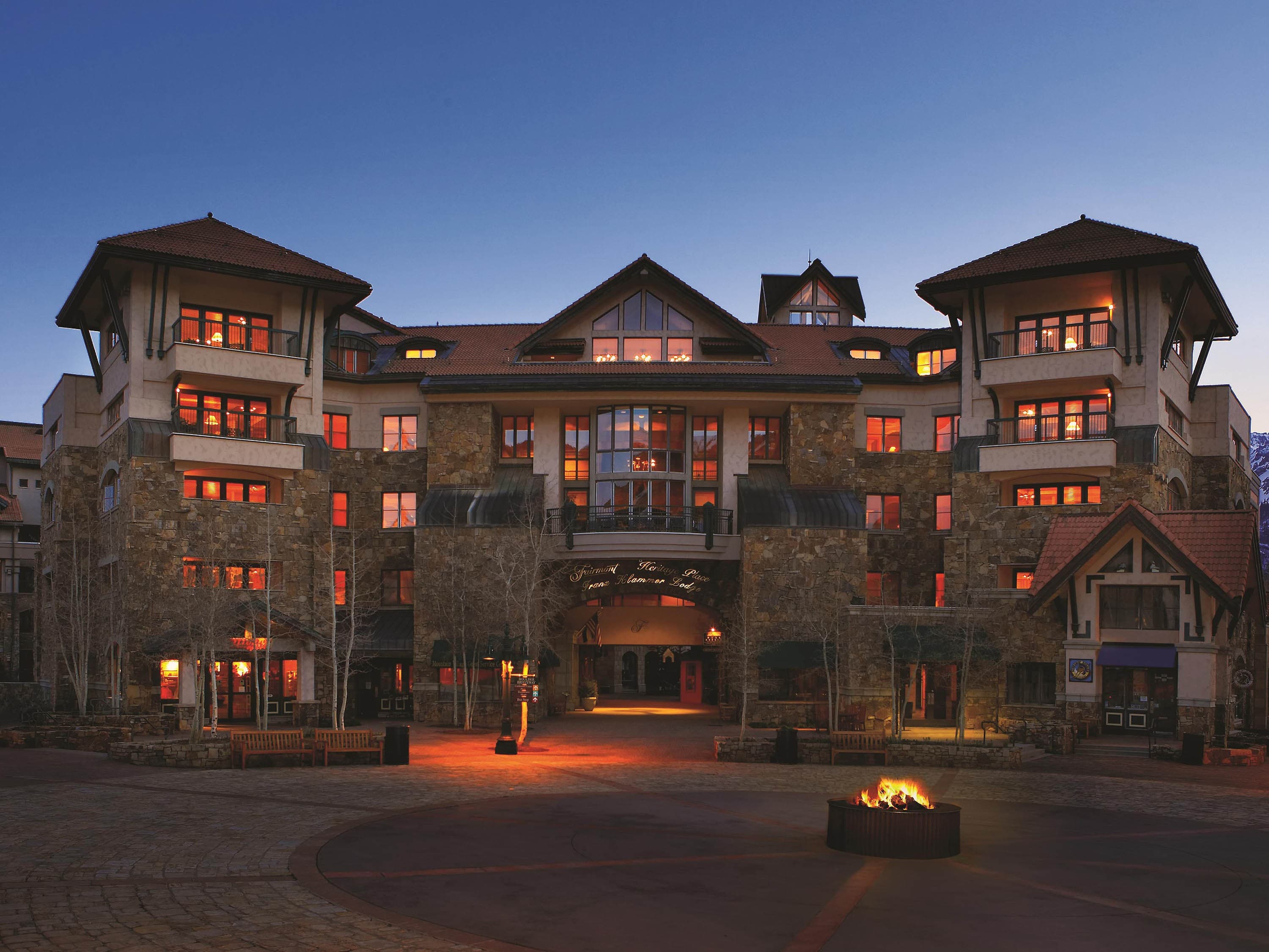 Lodge entrance and fire pit at dusk
