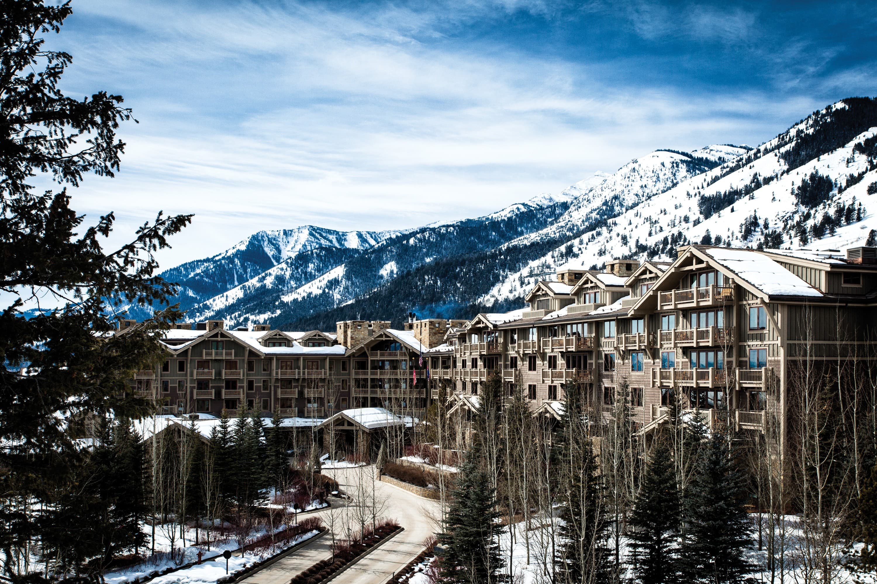 Resort and residences in snow below the ski mountain