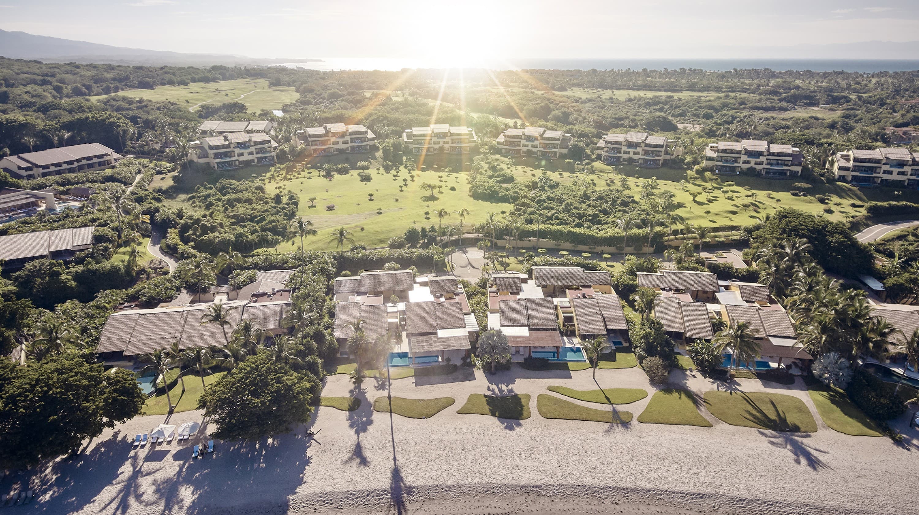 Aerial view of beachfront residences at sunset